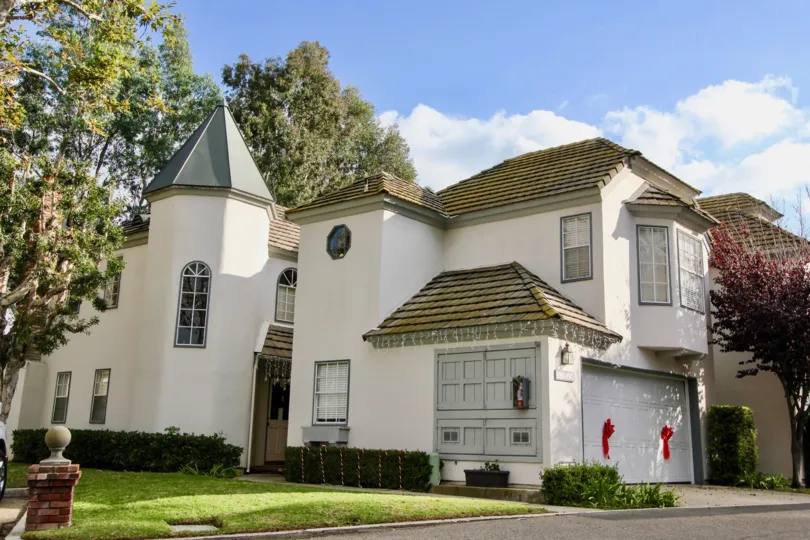 A beautigul home with tiled roof, and a turret and a nice lawn in the community of Villa De Cerise in Laguna Niguel, California