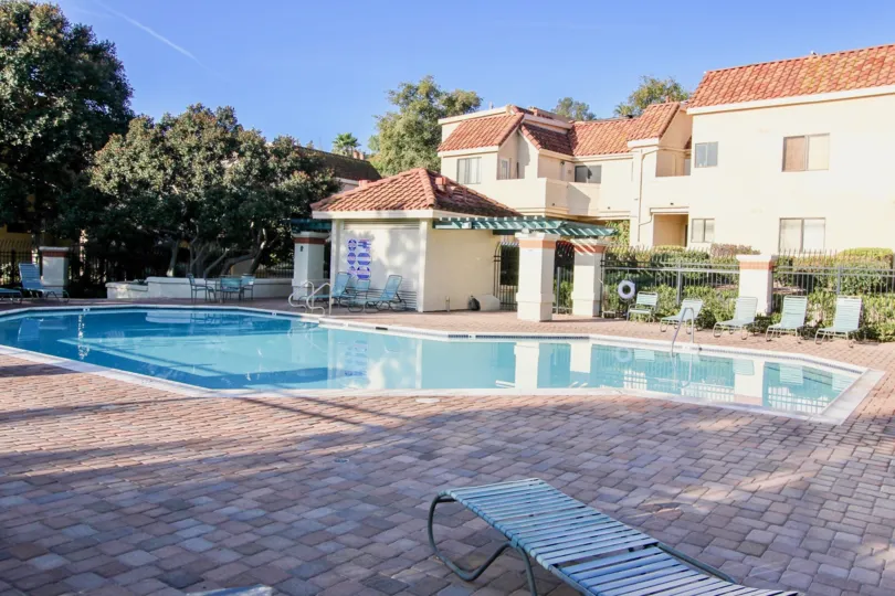 A blue swimming pool in the Villa Mira nearby a building.