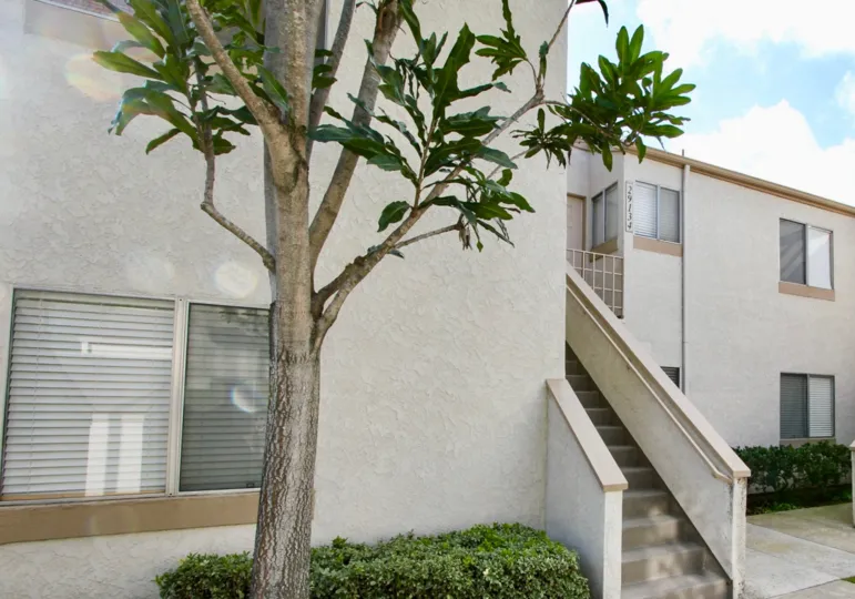 Side view of a white color house with an old type staircase