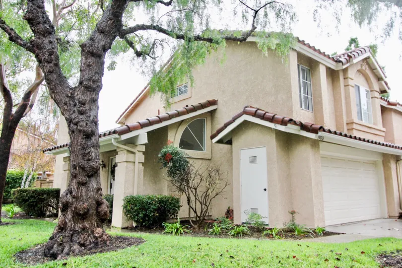 A sunny day in the area of Canyon Rim, trees, roof, condo, garage, door, window