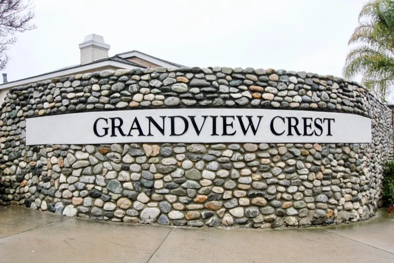 Circular multi-colored stone wall surrounding Grandview Crest in California.
