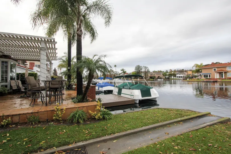 A cloudy day in Lake Forest Keys with a lake and houses and boats next to it