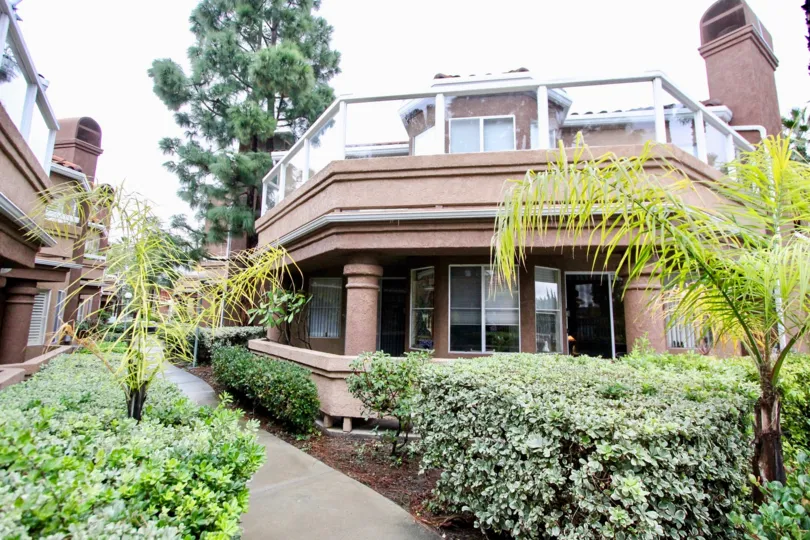 There are some plants in front of a building in the Lake Forest Shores.