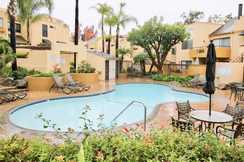 Nice swimming pool with flower garden between villas of Le Parc of Lake Forest