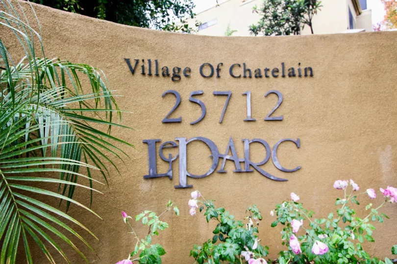 A day in the Le Parc with a sign on the wall nearby plants.