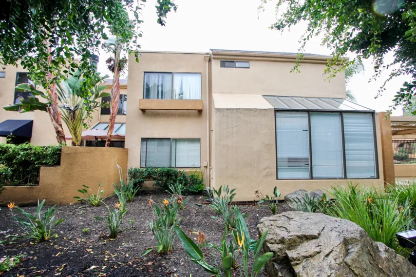 The garden in front of Le Parc apartment building with flowers and bushes.