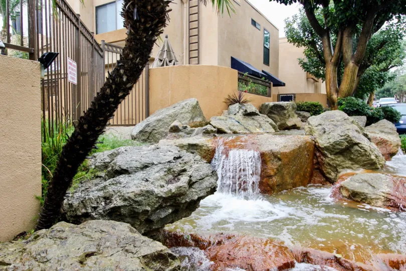 A pond with mini-waterfalls in the Le Parc community.