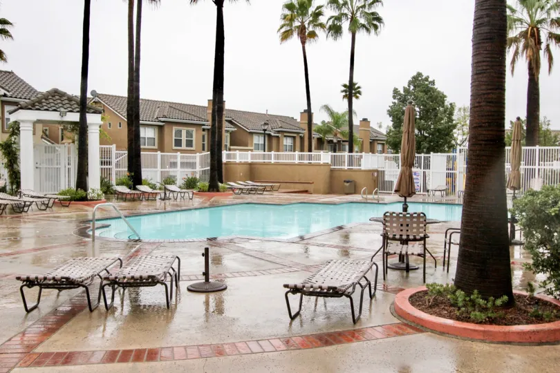 A beautiful swimming pool with zig zag shape and relaxing chairs in Montecido.