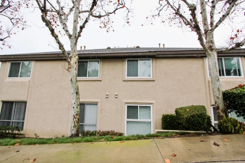 A tan building with windows and sidewalk in Old Trabuco Highlands community in Lake Forest, California.