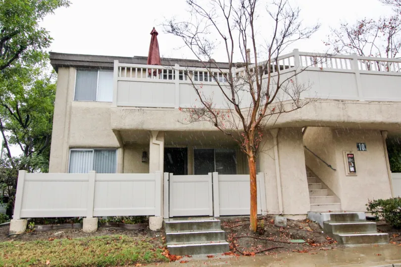 A closed red umbrella sits on a second floor balcony in Old Trabuco Highlands
