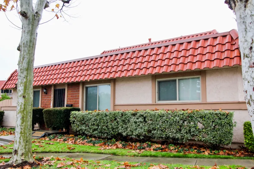red roofed home with beautiful bushes in the city of lake forest