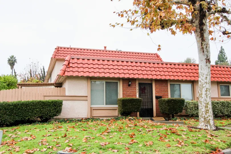 House with a front lwan and lush greenery in Lake forest