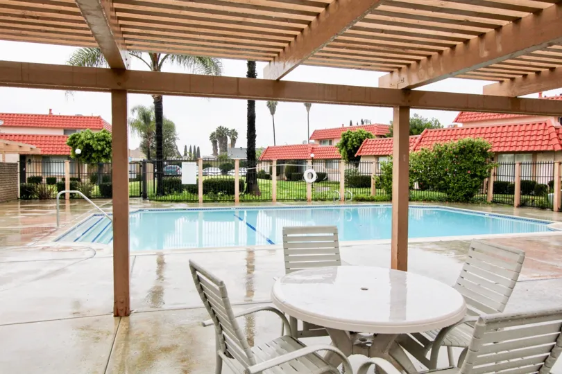 A swimming pool near by, some plants in the Rancho Viejo Condos.