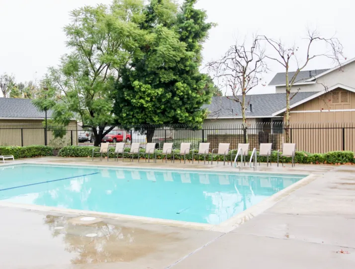 A SIGHT OF BEAUTIFUL SWIMMING POOL OF A BUILDING LOCATED IN A BUSY AREA