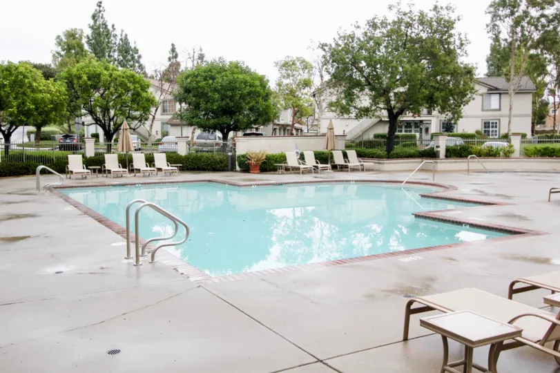 A poools die courtyard view of the Salerno community in Lake Forest, CA. on a clear day.