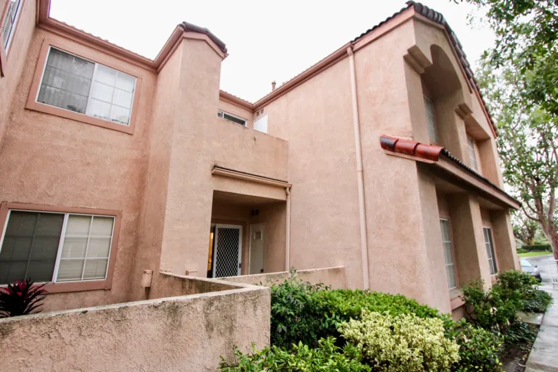 A cement pinkish tan home in Serrano Sandcastle community in Lake Forest, California.