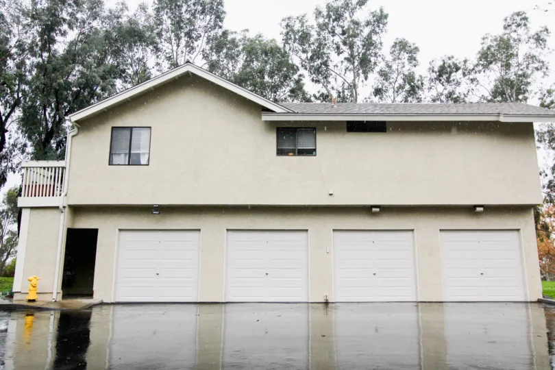 View of four single car garages and fire hydrant at Sycamore Glen in Lake Forest, California