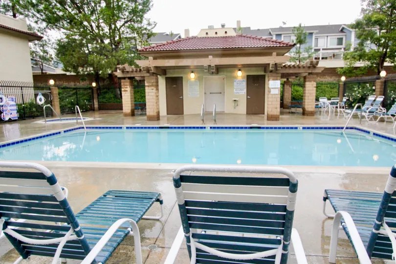 THE HOUSE IN THE TIERRA VISTA WITH THE SWIMMING POOL, LAMPS, CHAIRS, PLANTS, TREES