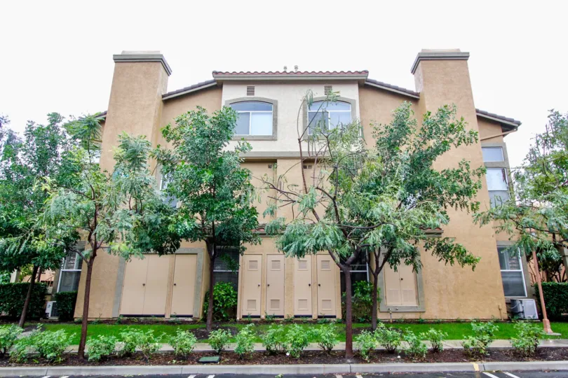 Four small doors protect utility closets on a building in the Tuscany at Foothill Ranch community