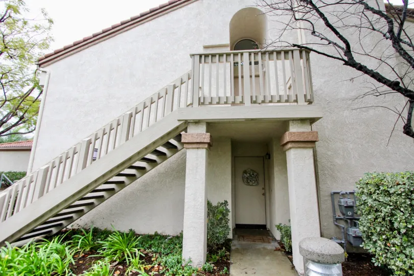 A stair case going up to a door and a door on the first floor in Villorio community in Lake forest, California.