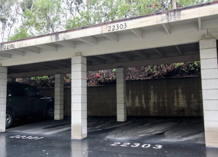 Two empty parking spots on a wet day in the Vista Verde Townhomes in Lake Forest California.