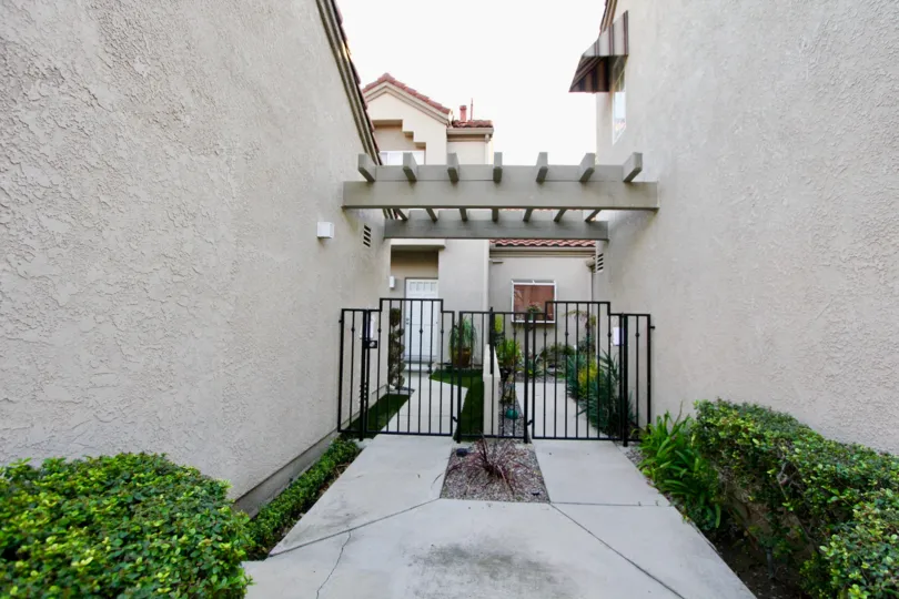 A narrow path way the building with iron gate in Coral Gardens.