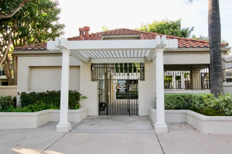 THE BUILDING IN THE Coral Gardens WITH THE GATE, TREES, PLANTS