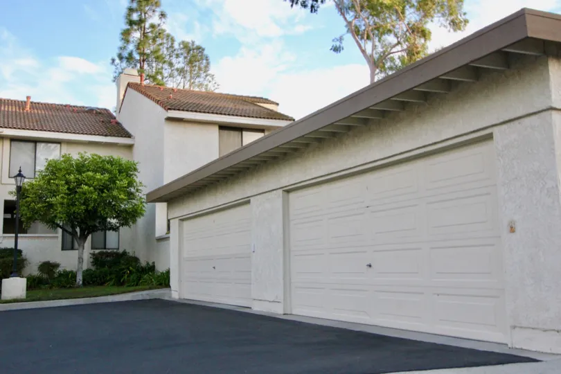 A large home in Mission Viejo, CA with two garages, a tree, and two floors.