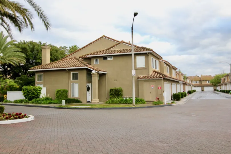 Villas at road point with street lamps and trees around in Emerald Point I of Mission Viejo