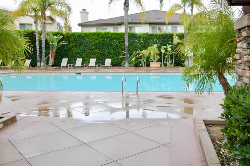 The swimming pool with tropical landscaping with palms at Magdalena in Mission Viejo, California