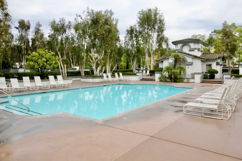 Three stairs and a railing provide access to the community pool in the Mirasol community.