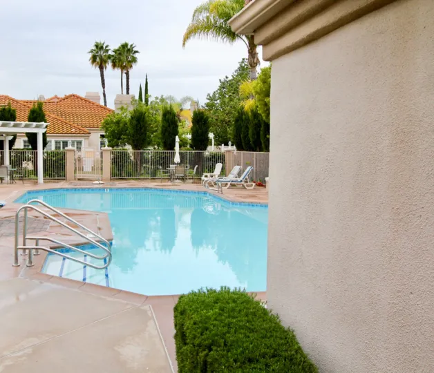 A sunny day in the Palmia Courts 2 with swimming pool and chairs.