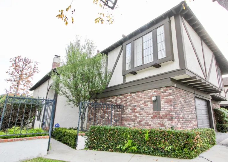 a warm day in the 16th & tustin with house that has stone walls and gardens