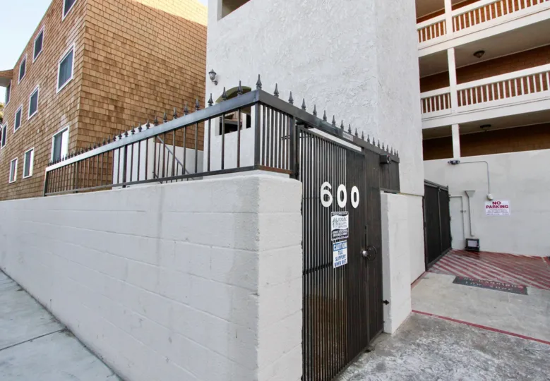 a warm day in the balboa peninsula with building that has out gate of no is 600 and white walls