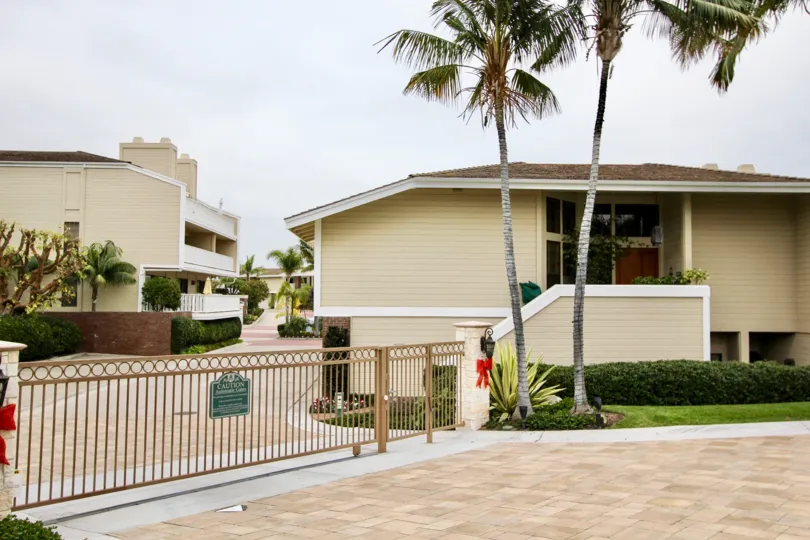 a warm day in the bayside cove with house that his two tree in front and still gate