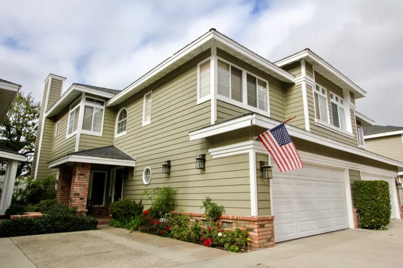 a warm day in the beacon court with house that has flag and white door