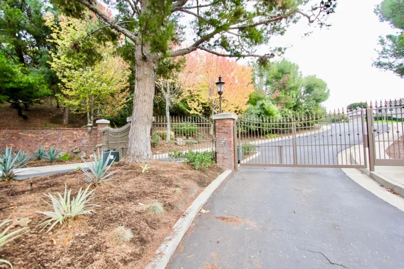A day in the Belcourt Hill with a iron gate and road.