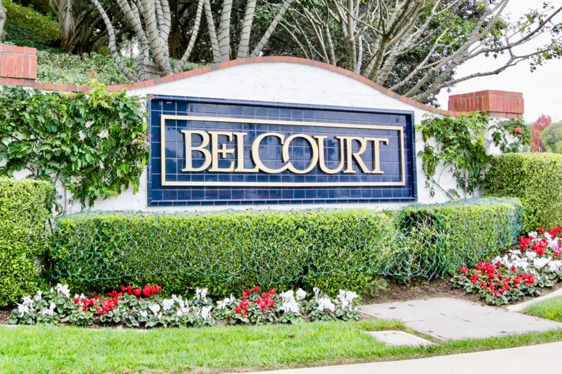 a warm day in the belcourt terrace with building that has name of belcourt and flowers