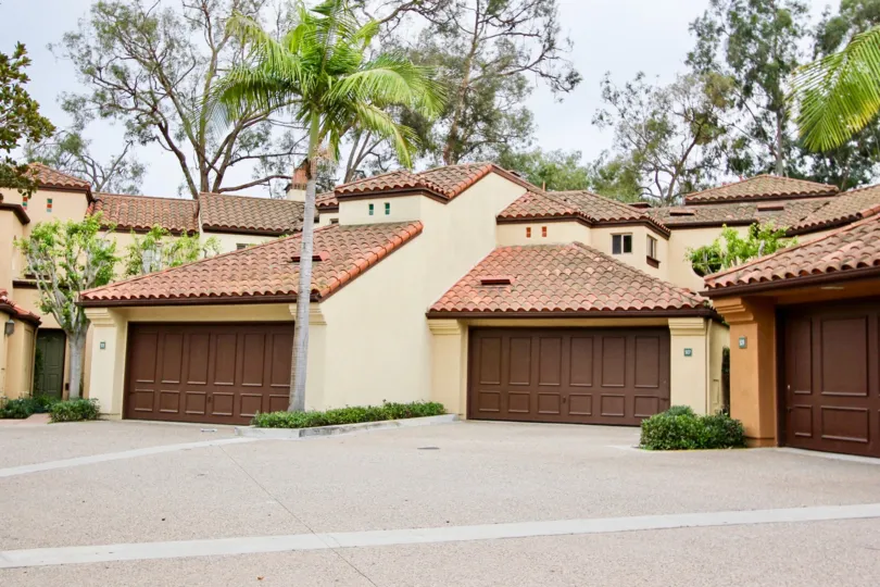 VERY NICE HOUSE WITH BROWN COLOR DOOR INFRONT OF HOUSE AND THE TREES ARE VERY BEAUTIFUL