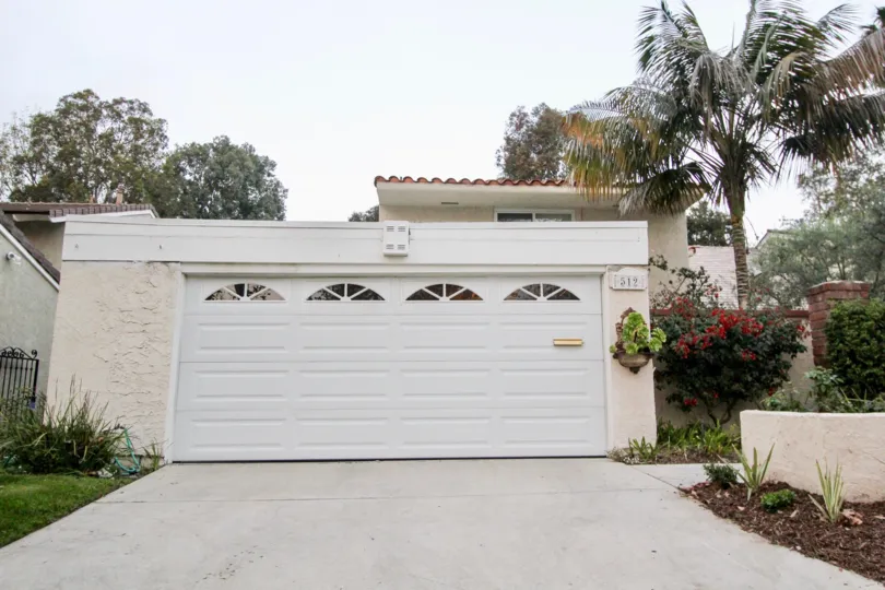 THE 512 BUILDING IN THE BLUFFS TENNIS VILLAS WITH THE PLANTS, TREES, SHUTTER