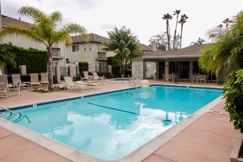 a warm day in the dover village with house that has swimming pool and trees