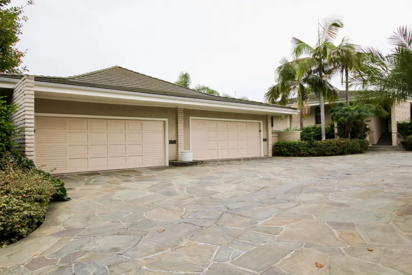 A day in the Granville with a garage gate and palm trees.