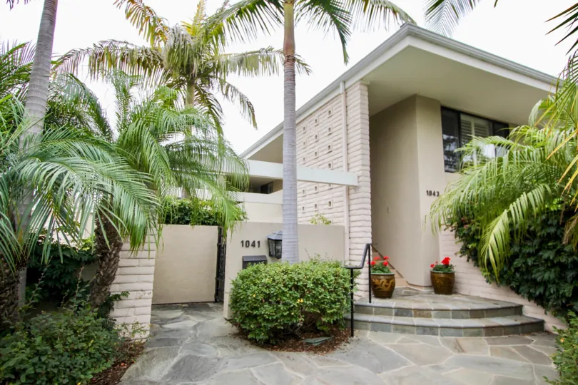 a warm day in the granville with house that has front of tress in no of 1041 and flowers