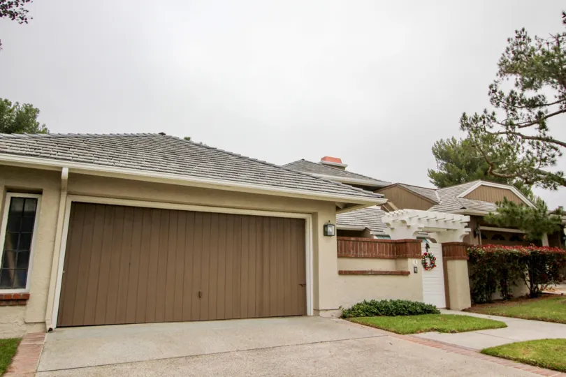 A large brown fence like garage door on a home in Harbor Ridge Crest in Newport Beach California