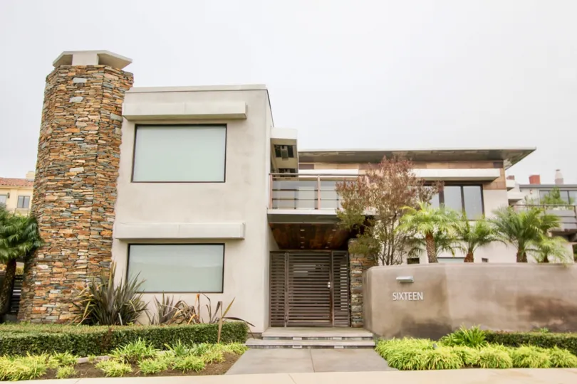 a warm day in the harbor ridge estates with building that has stone on chif top and named sixteen