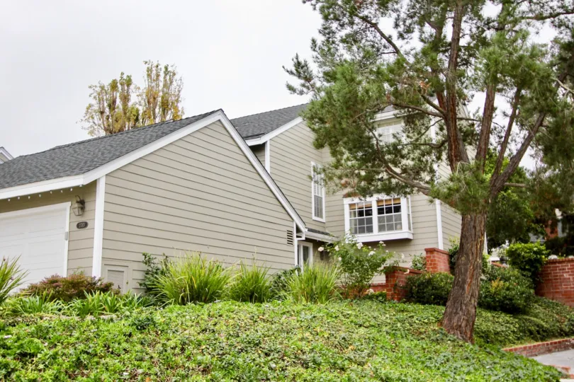 Back to the House in Harbor View Knoll has Bushes with plants and trees