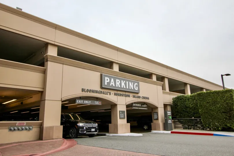 Car exiting parking garage at Meridian shopping center in Newport Beach, CA