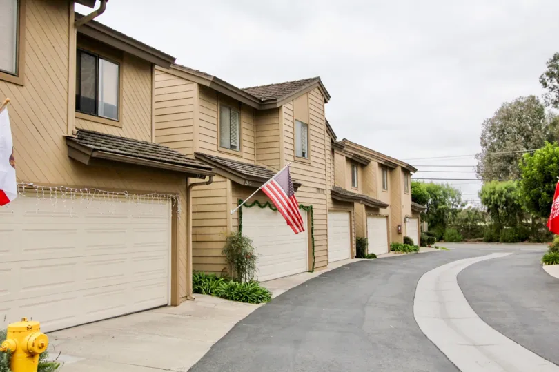 THE APARTMENTS IN THE NEWPORT GLEN WITH THE FLAGS, THAR ROAD, PLANTS, TREES, SHUTTERS