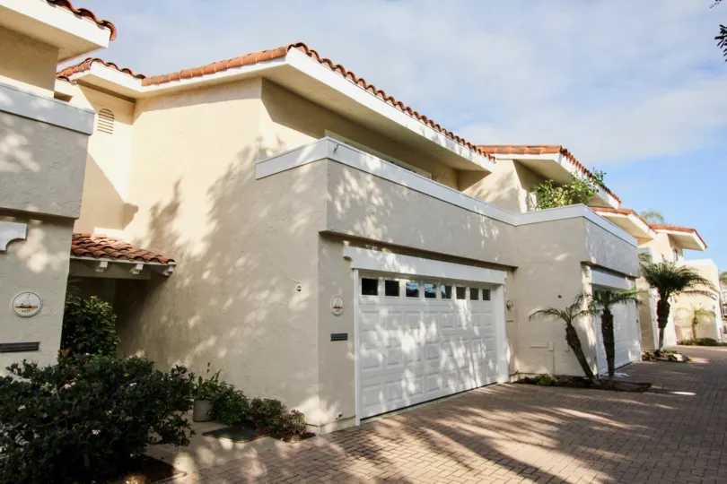 Sideview with garage door and open space of Newport Marina Villas community, Newport Beach, CA