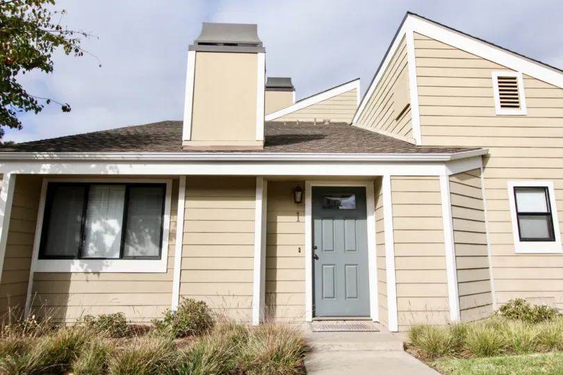 THE 1ST BUNGALOW IN THE NEWPORT TERRACE WITH THE PLANTS, GRASSES, WOODEN DOOR